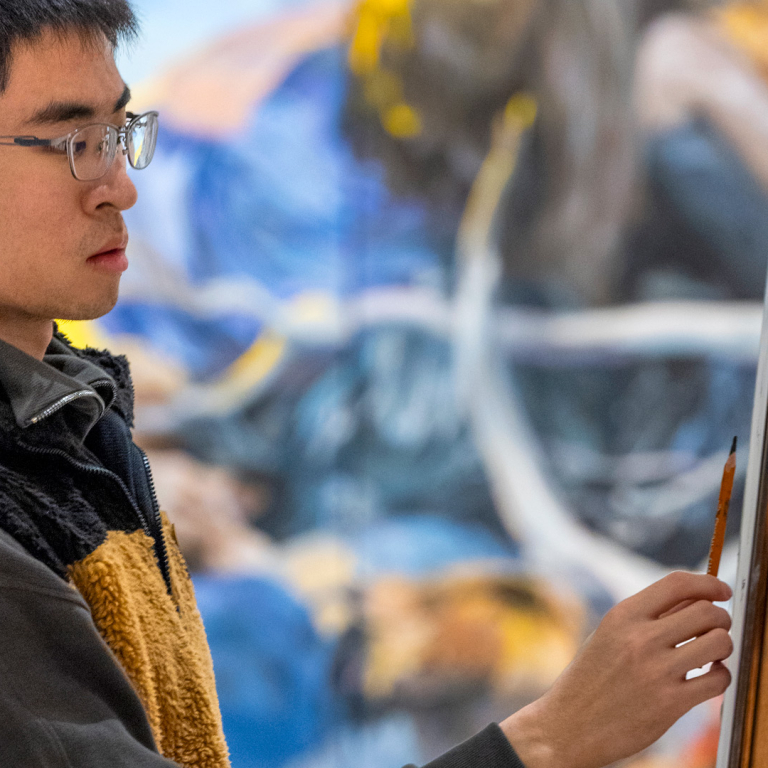 painter standing at easel