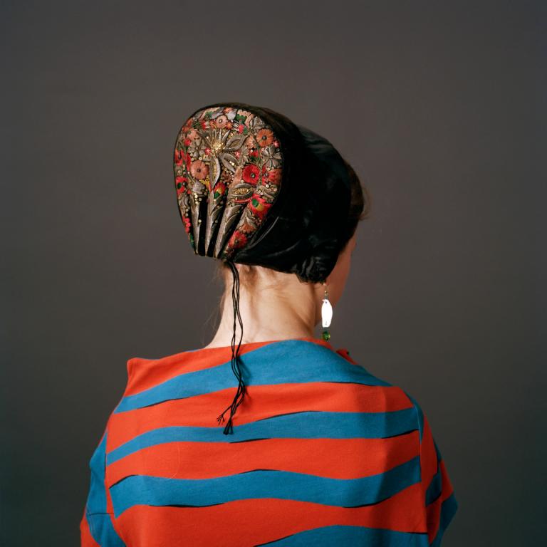 Photograph of back of woman wearing danish bonnet