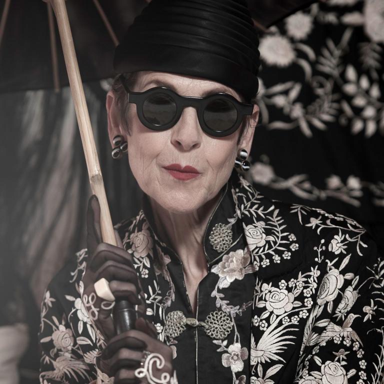 Black and white photo of style icon Tziporah Salamon with parasol