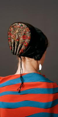Photograph of back of woman wearing danish bonnet
